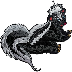 May include: An embroidered patch featuring a skunk with black fur and a prominent white stripe running from its head down its back to its large, bushy tail. The skunk has small gold-colored paws, a pink nose, and blue eyes, rendered in detailed thread work.