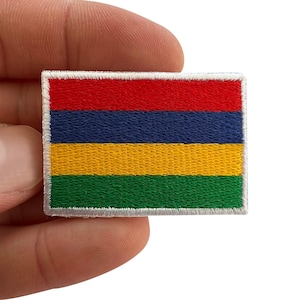 May include: A rectangular embroidered patch featuring the national flag of Mauritius, which consists of four horizontal bands in red, blue, yellow, and green, finished with a white stitched border around the entire perimeter of the fabric.