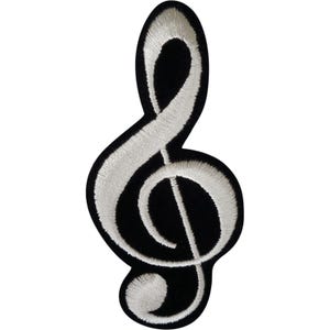May include: A black embroidered patch in the shape of a treble clef symbol. The musical notation design is outlined and filled with white thread, creating a high-contrast appearance against the solid black fabric background of the patch.