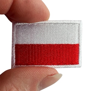 Puede incluir: Un parche rectangular bordado que presenta la bandera nacional de Polonia, que consta de dos franjas horizontales de igual altura, con blanco en la parte superior y rojo en la parte inferior, acabado con un borde cosido blanco alrededor.