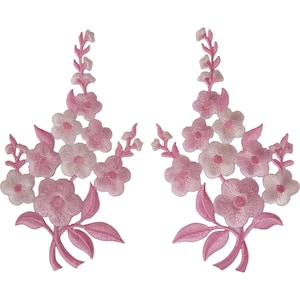 May include: Two identical embroidered floral patches featuring light pink and soft pink blossoms arranged in a vertical, branching spray pattern with small leaves at the base. The design consists of five-petaled flowers and buds.