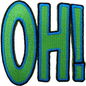 May include: An embroidered patch featuring the letters O and H followed by an exclamation point. The letters are lime green with a bright blue inner border and a thick black outer border, creating a bold, high-contrast graphic design element.