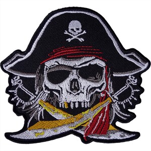 May include: An embroidered patch featuring a black pirate hat with a white skull and crossbones emblem. Below the hat is a skull wearing a red bandana, positioned over two crossed silver swords with yellow accents and detailed hilt designs.