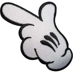 May include: A white embroidered patch in the shape of a cartoon glove with a black stitched outline. The glove is depicted with four fingers, with the index finger extended outward to point, and three black lines indicating the knuckles on the back.