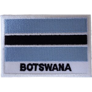 May include: A rectangular embroidered patch featuring the flag of Botswana with horizontal stripes of light blue, white, and black. The word BOTSWANA is stitched in bold black capital letters across the bottom white stripe of the patch.