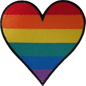 May include: A heart-shaped embroidered patch featuring horizontal stripes in red, orange, yellow, green, blue, and purple. The patch has a thick black stitched border outlining the entire heart shape, creating a distinct and clean edge for application.