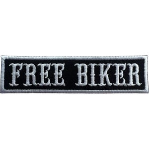 May include: A rectangular embroidered patch with a black background and a white border. The text FREE BIKER is stitched in white capital letters across the centre in a bold, serif font. The patch has a clean, finished edge with white thread.