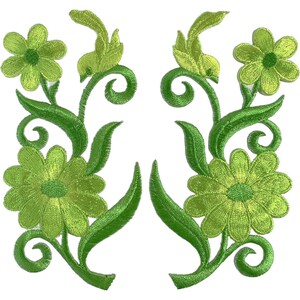 May include: A pair of matching embroidered patches featuring lime green flowers with darker green centers, surrounded by swirling green vines and pointed leaves. The design is symmetrical, with each patch displaying a large bottom flower and a smaller top flower connected by curved stems and foliage.