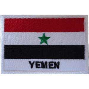 May include: A rectangular embroidered patch featuring the flag of Yemen with horizontal red, white, and black stripes. A green five-pointed star is centred in the white stripe, and the word YEMEN is stitched in black capital letters below it.