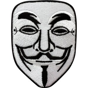 May include: An embroidered patch featuring a stylized Guy Fawkes mask design. The mask is primarily white with black embroidered details for the eyebrows, eyes, mustache, and pointed beard, all outlined with a thick black border on a white background.