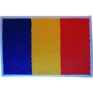 May include: A rectangular embroidered patch featuring the vertical tricolor flag of Romania. The design consists of three equal vertical bands of blue on the left, yellow in the center, and red on the right, all bordered by a white stitched edge.