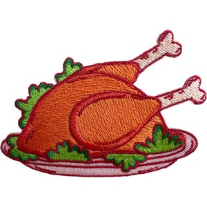 May include: An embroidered patch depicting a roasted turkey on a white platter with green lettuce garnish. The turkey is orange and brown with two white bones protruding. The platter has a red border and the entire design is outlined in red thread.