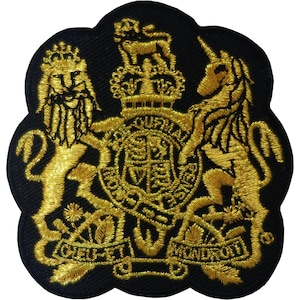 May include: A black embroidered patch featuring the Royal Coat of Arms of the United Kingdom in gold thread. The design includes a lion and a unicorn flanking a central shield topped with a crown, with the motto Dieu et mon droit at the base.