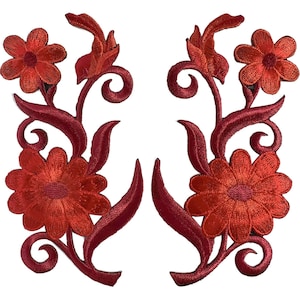May include: A pair of symmetrical red embroidered floral patches featuring two distinct flowers per piece, connected by swirling vine stems and elongated leaves. The embroidery uses a vibrant red thread with a subtle sheen, creating a detailed botanical design.