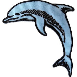 May include: An embroidered patch in the shape of a leaping dolphin. The dolphin is light blue with black thread detailing outlining its body, fins, and tail, creating a distinct contrast against the light blue fabric fill of the patch design.