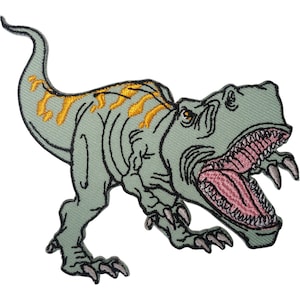May include: An embroidered patch of a light green Tyrannosaurus Rex dinosaur with a long tail, yellow stripes along its back, and an open mouth revealing a pink interior with sharp teeth. The design features black outlines and textured stitching.