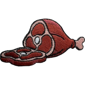 May include: An embroidered patch featuring a piece of raw meat on the bone with a separate slice in front. The design uses shades of deep red and pink thread with a black outline, depicting the muscle structure and a small white bone at the end.