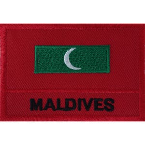 May include: A rectangular embroidered patch featuring a deep red background. Centered is a green horizontal rectangle containing a white crescent moon. Below the green rectangle, the word MALDIVES is stitched in bold, black capital letters.