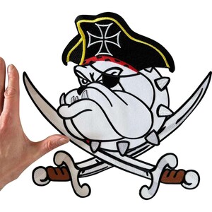 May include: An embroidered patch featuring a white bulldog wearing a black pirate hat with a white cross emblem and a black eye patch. The bulldog is positioned above two crossed silver swords with brown handles, all outlined in thick black thread.