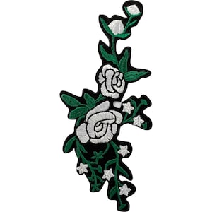May include: An embroidered patch featuring a vertical arrangement of white roses and small white star-shaped flowers connected by green stems and leaves. The design is set against a solid black background with a distinct black border outline.