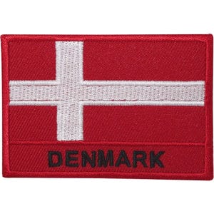 May include: A rectangular embroidered patch featuring the flag of Denmark with a red background and a white Nordic cross. The word DENMARK is stitched in black capital letters across the bottom section of the red field on the fabric patch.