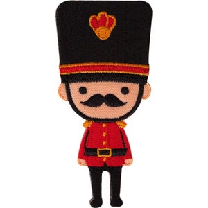 May include: An embroidered patch depicting a stylised guard figure wearing a tall black bearskin hat with a red emblem, a bright red tunic with gold accents, a black belt, and black trousers. The figure has a tan face with a black moustache.