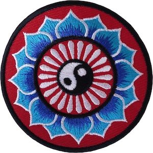 May include: A circular embroidered patch featuring a central black and white yin-yang symbol surrounded by a ring of white petals on a red background, encircled by a larger layer of blue and light blue lotus-style petals with a black border.