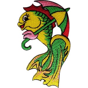 May include: An embroidered patch featuring a yellow fish with green scales, pink lips, and a large eye. The fish is holding a colourful umbrella with red, green, and yellow panels over its head. The design is finished with a detailed stitched border.