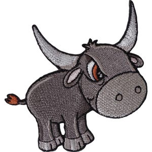 May include: An embroidered patch featuring a cartoon bull with dark grey fur, large curved horns, and a light grey snout. The bull has orange eyes, small ears, and a small tail with a reddish-brown tip. The entire design is outlined in black thread.