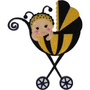 May include: An embroidered patch featuring a baby with a yellow and black bee-themed hat and costume sitting inside a black and yellow striped pram. The pram has two black wheels with white spokes and black antennae extending from the top.