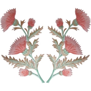 May include: Two symmetrical embroidered patches featuring thistle flowers in shades of coral pink and muted green. Each patch displays a central blooming flower, a smaller bud, and jagged, textured leaves extending from a central stem.