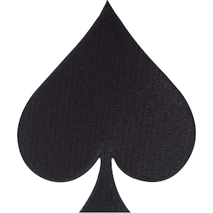 May include: A solid black embroidered patch in the shape of a spade playing card suit. The design features a pointed top, two rounded lobes, and a narrow stem base, all rendered with a dense, textured thread finish on a flat surface.