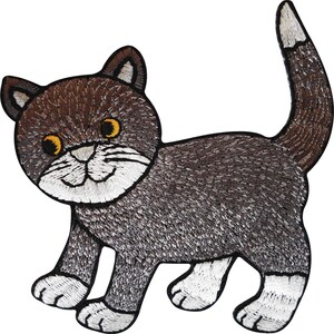 May include: An embroidered iron-on patch featuring a brown and grey cat with a white muzzle, white paws, and a white-tipped tail. The cat has large yellow eyes, a black stitched outline, and detailed thread work depicting fur texture throughout.
