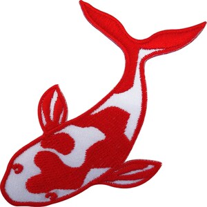 Op de afbeelding: Een geborduurde patch in de vorm van een koikarper. De vis heeft een levendig rood en wit patroon met een gebogen lichaam, een opvallende staartvin en twee kleinere zijvinnen, allemaal afgewerkt met een strakke, gestikte rand.