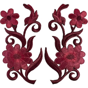 May include: A pair of matching dark red floral embroidered patches featuring two distinct flower heads connected by swirling stems and pointed leaves. The embroidery is dense with a consistent deep burgundy thread colour throughout the design.