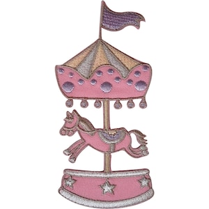 May include: An embroidered patch featuring a carousel ride with a pink horse, a pink canopy with purple polka dots, a purple flag on top, and a pink base decorated with silver stars. The design uses pink, purple, silver, and beige thread colors.