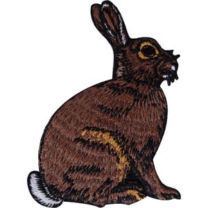 May include: An embroidered patch in the shape of a brown rabbit sitting in profile. The rabbit features dark brown fur with golden-brown highlights, a white tail, and a black outline. The design shows the rabbit facing right with long ears.
