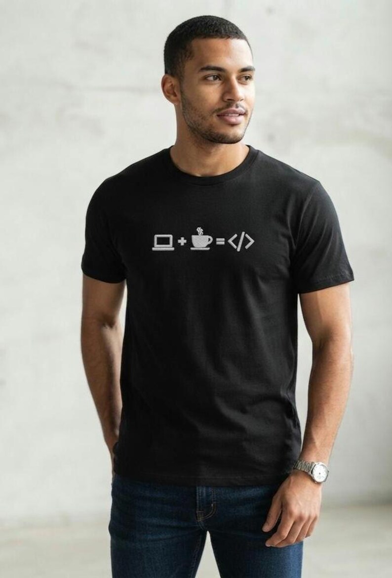 May include: A black short-sleeved t-shirt featuring a white graphic print on the chest. The design consists of a laptop icon, a plus sign, a coffee cup icon, an equals sign, and a code bracket symbol, representing the equation laptop plus coffee equals code.
