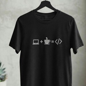 May include: A black short-sleeved t-shirt featuring a white graphic print on the chest. The design displays a laptop icon, a plus sign, a steaming coffee cup icon, an equals sign, and a code bracket symbol, representing the equation laptop plus coffee equals code.