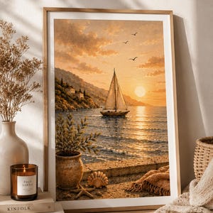 May include: A framed wall art print depicting a sailboat on a calm sea at sunset. The scene features a coastal landscape with hills, houses, and a stone terrace in the foreground with a potted plant, a seashell, a starfish, and a draped blanket.