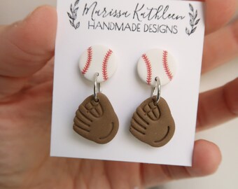 May include: A pair of handmade baseball-themed earrings. Each earring features a white baseball with red stitching and a brown baseball glove charm.