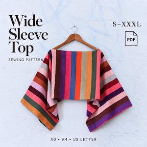 May include: A wide sleeve top sewing pattern featuring a multi-coloured vertical striped design in shades of purple, pink, orange, green, and blue. The text reads Wide Sleeve Top, Sewing Pattern, S-XXXL, PDF, A0, A4, US Letter.
