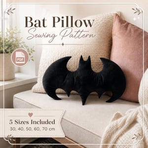 May include: A black bat-shaped plush pillow with pointed ears and wings. The image includes text reading Bat Pillow Sewing Pattern and 5 Sizes Included 30, 40, 50, 60, 70 cm, along with a PDF icon. The pillow is displayed against a neutral background.