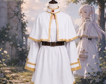 Peut inclure: Une robe blanche avec une cape assortie dotée d'une bordure dorée, un col montant avec une gemme rouge et une ceinture marron foncé à boucle métallique. Le vêtement présente des manches longues à poignets dorés et le texte Matrix Cosplay.