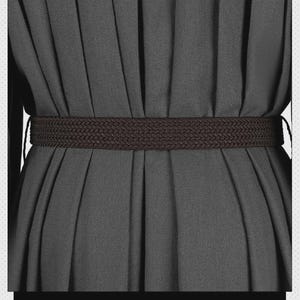 May include: A dark brown braided belt worn over a solid dark gray pleated garment. The belt features a consistent woven texture and is positioned horizontally across the waist area, cinching the fabric of the pleated dress or skirt.