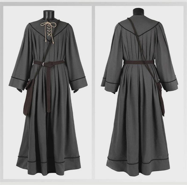 May include: A floor-length charcoal gray robe featuring long sleeves, a dark brown belt, and a small matching pouch. The neckline includes a beige lace-up closure with thin cords. Dark piping accents the seams, shoulders, and hemline.