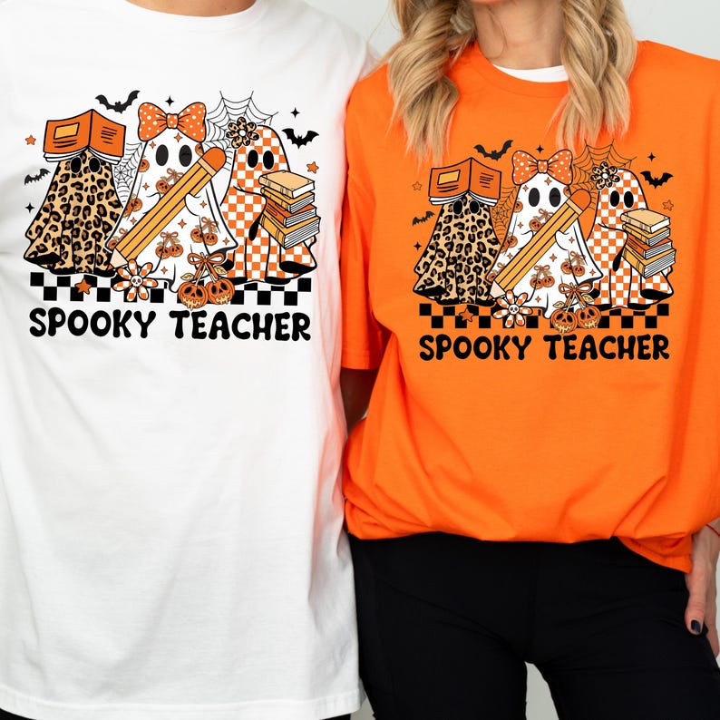May include: A white t-shirt and an orange t-shirt each featuring a graphic of three ghosts with books, a pencil, and a bow. The design includes a black and white checkered border and the text SPOOKY TEACHER in bold black letters.