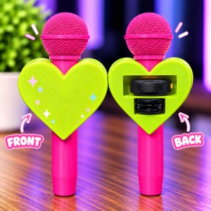 May include: Two pink microphones with bright green heart-shaped attachments. The front attachment features small star icons, while the back attachment reveals a black rectangular component. The text FRONT and BACK are visible with arrows.