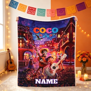 May include: A plush fleece blanket featuring a vibrant scene from the movie Coco, with the title Coco at the top and a placeholder for a name at the bottom. The design displays characters playing guitars in a colorful town square at night.