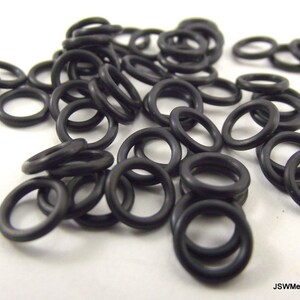 May include: A pile of black rubber o-rings. The o-rings are small and round, and they are all the same size.